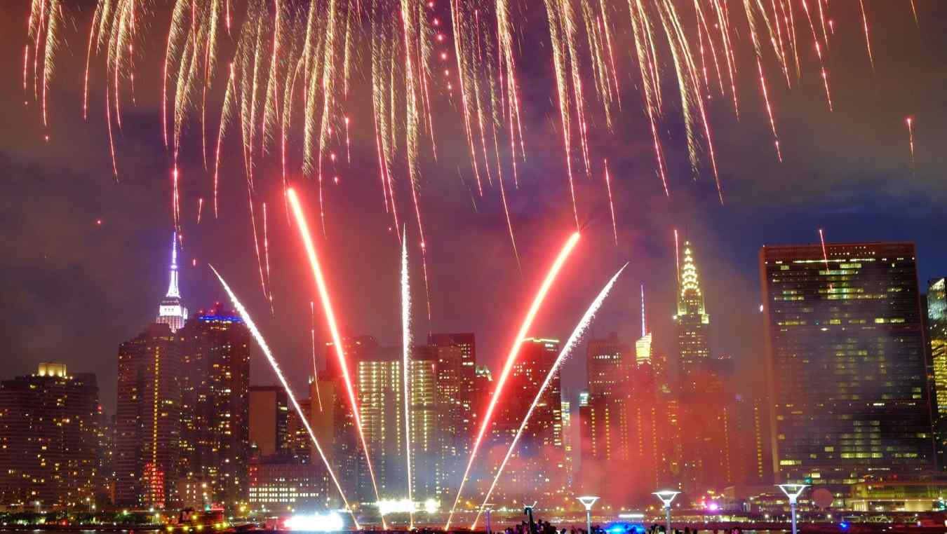 The Empire State Building and the Christal Building are seen during the Macy's 4th of July fireworks show from Queens, New York on July 4, 2017.