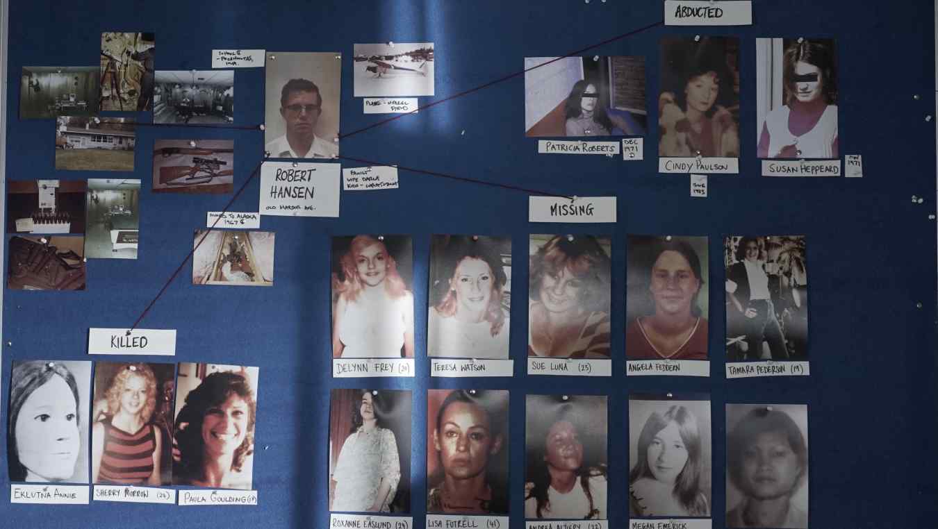 The murder and missing board, showing photos of Hansen’s victims and crime scene photos