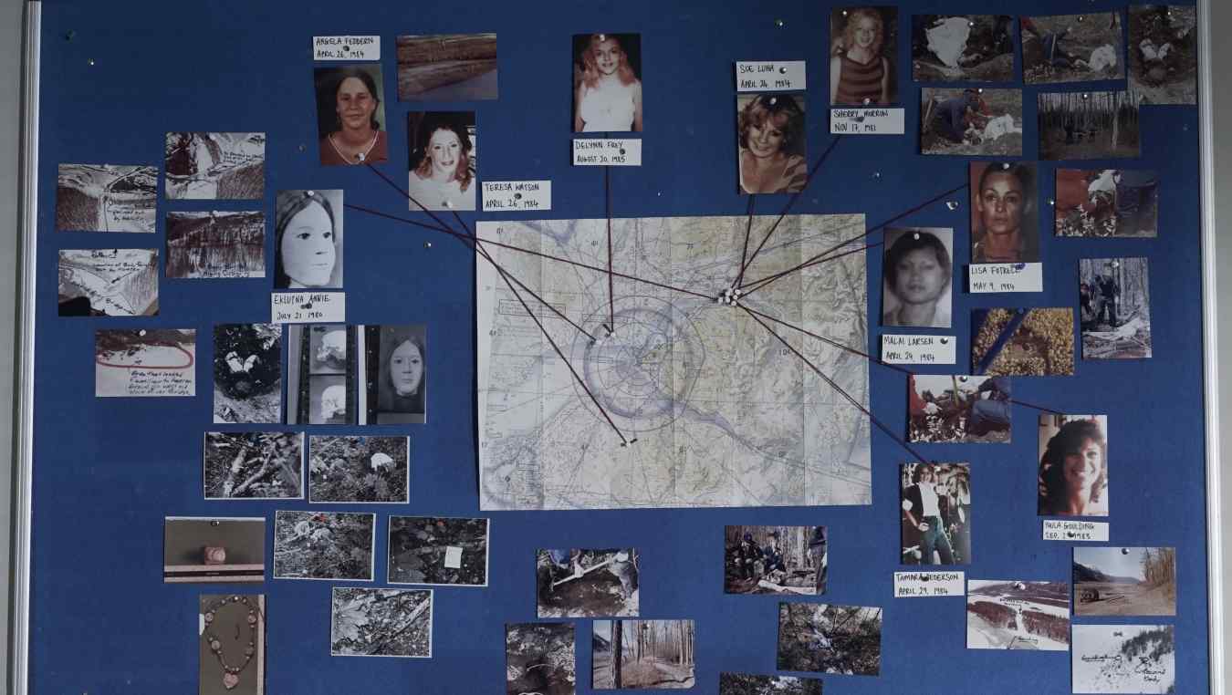 The murder map, with photos of a selection of Hansen’s victims with string pointing to where they were found, and crime scene photos