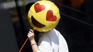 A woman holds a balloon as she walks past a store on Valentine's Day