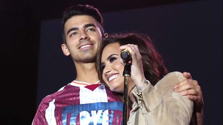 Recording artists Joe Jonas of DNCE (L) and Demi Lovato perform onstage during the Demi Lovato and DNCE Concert for Marriott Rewards members