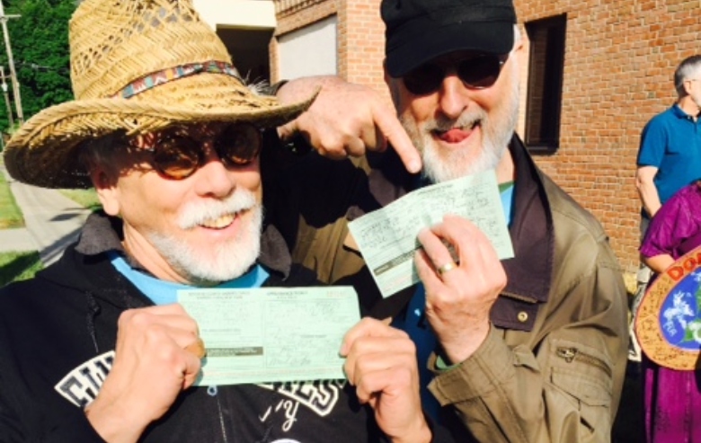 JG Hertzler and Jamie Cromwell participated in an ant-fracking protest. They are pictured here, each holding his "notice to appear"