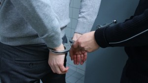 Stock photo of a person being arrested by a police officer