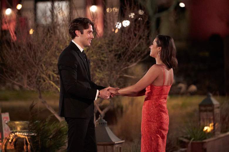 Katie Thurston and Greg holding hands.