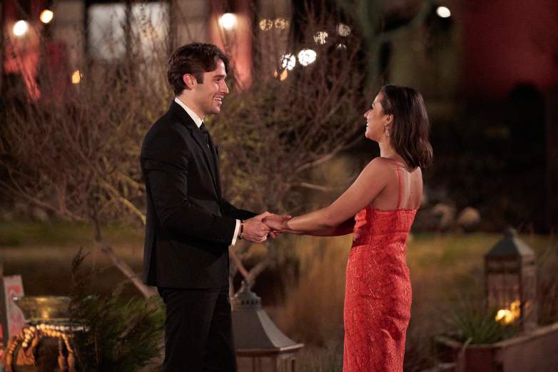 Katie Thurston and Greg holding hands.