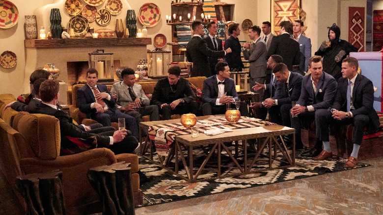 Katie Thurston's suitors sitting in a living room.