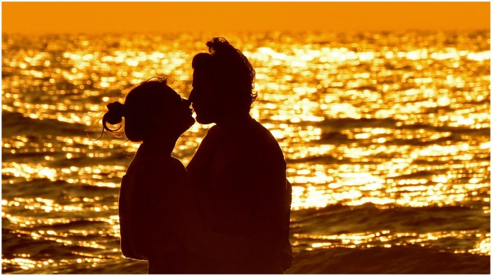 A couple kissing at sunset