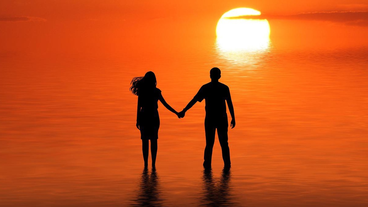 Couple on beach at sunset
