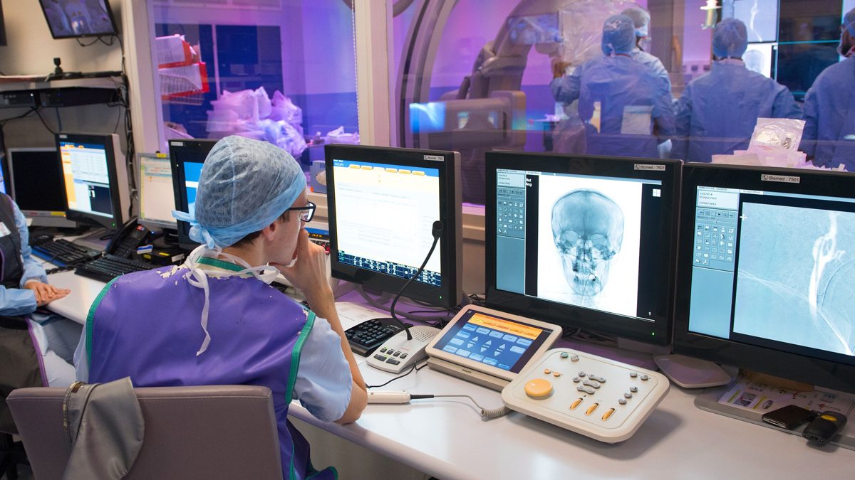Doctor looks at head scan