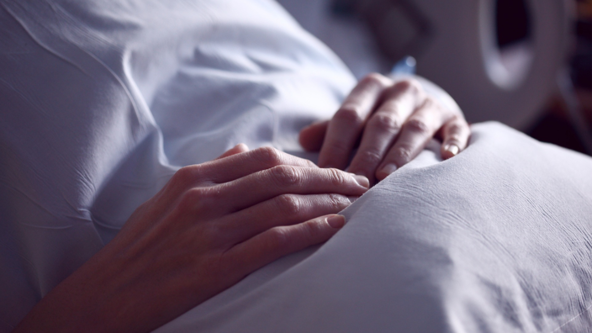 A woman in a hospital bed.