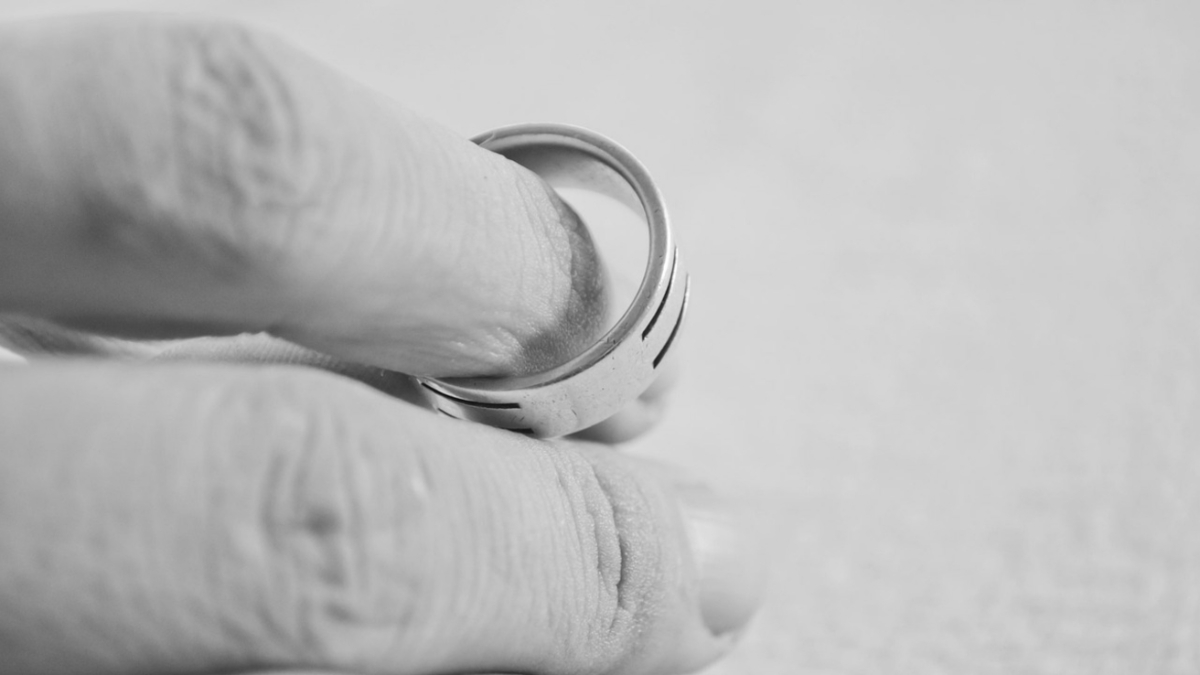 Man removing wedding ring.