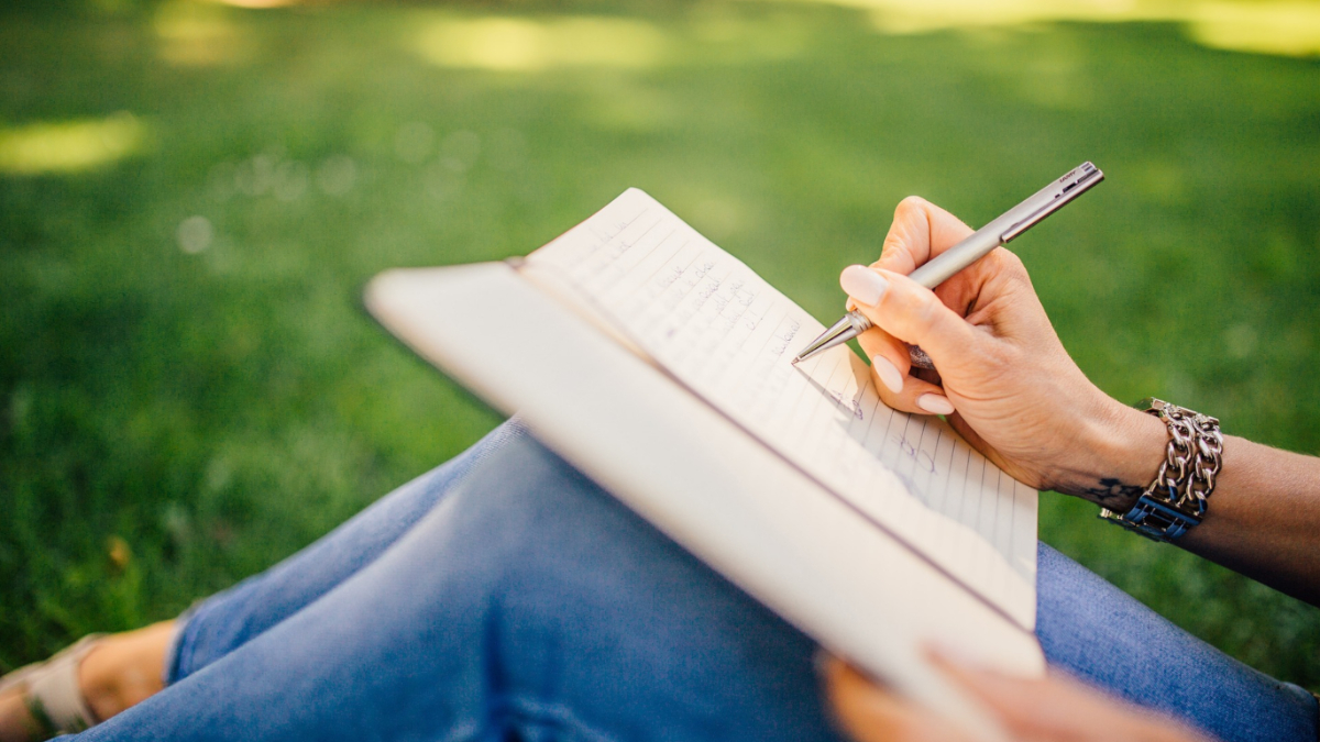 A woman writing in a book.
