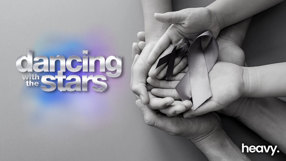 Hands cupping cancer ribbons