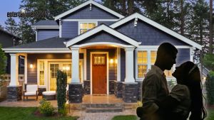 A couple in front of a house.