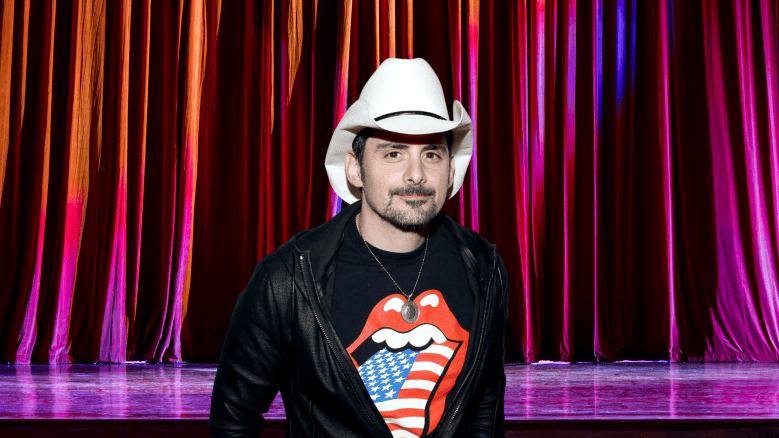 Brad Paisley in front of a stage curtain