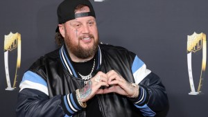 Jelly Roll making a heart sign with his hands
