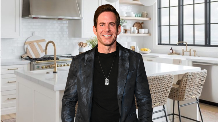 Tarek El Moussa stands in a kitchen