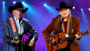 Willie Nelson and George Strait play guitar