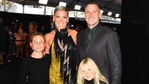 Carey Hart and Pink smiling with their children