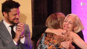 Tyler Hynes applauds as Hunter King hugs her mom