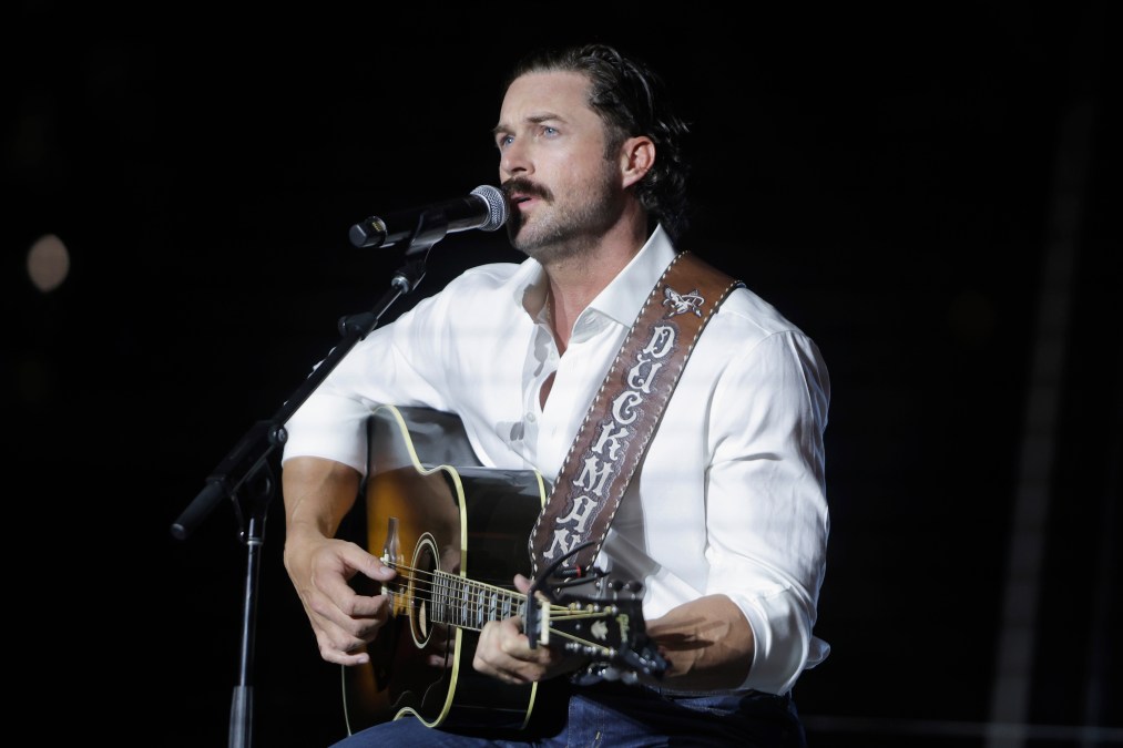 Riley Green playing guitar and singing