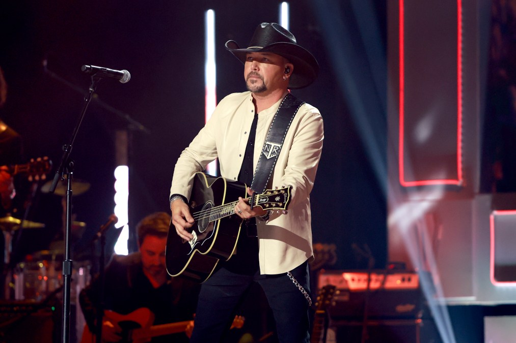 Jason Aldean playing guitar on stage