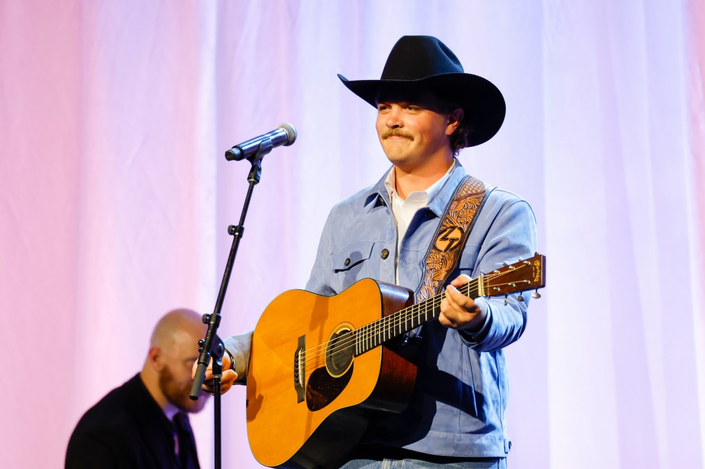 Zach Top playing guitar on stage