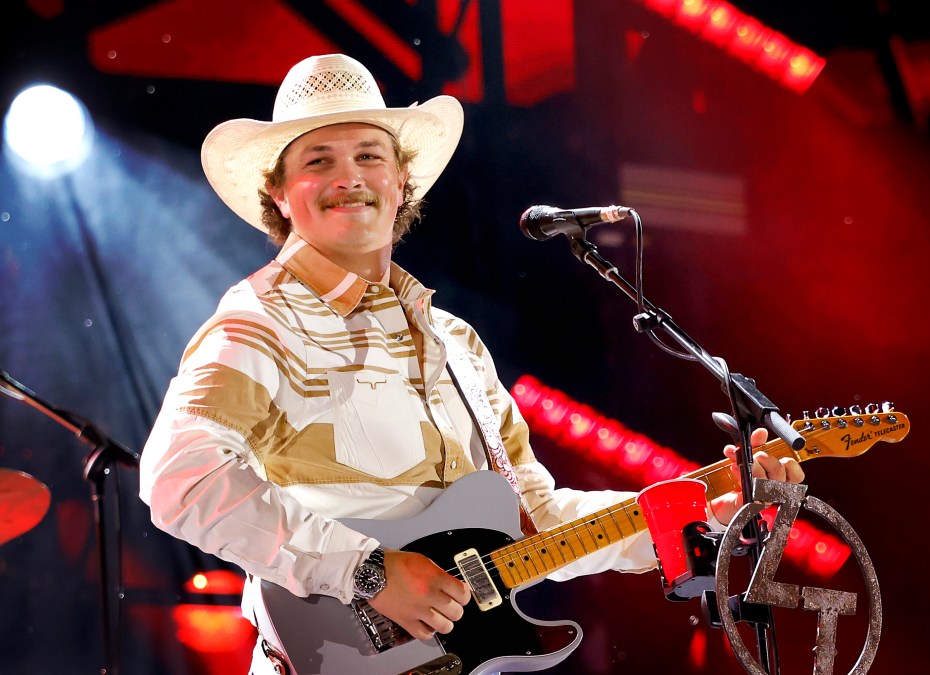 Zach Top holding a guitar