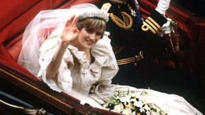 return to Buckingham Palace by carriage after their wedding, 29th July 1981. She wears a wedding dress by David and Elizabeth Emmanuel and the Spencer family tiara