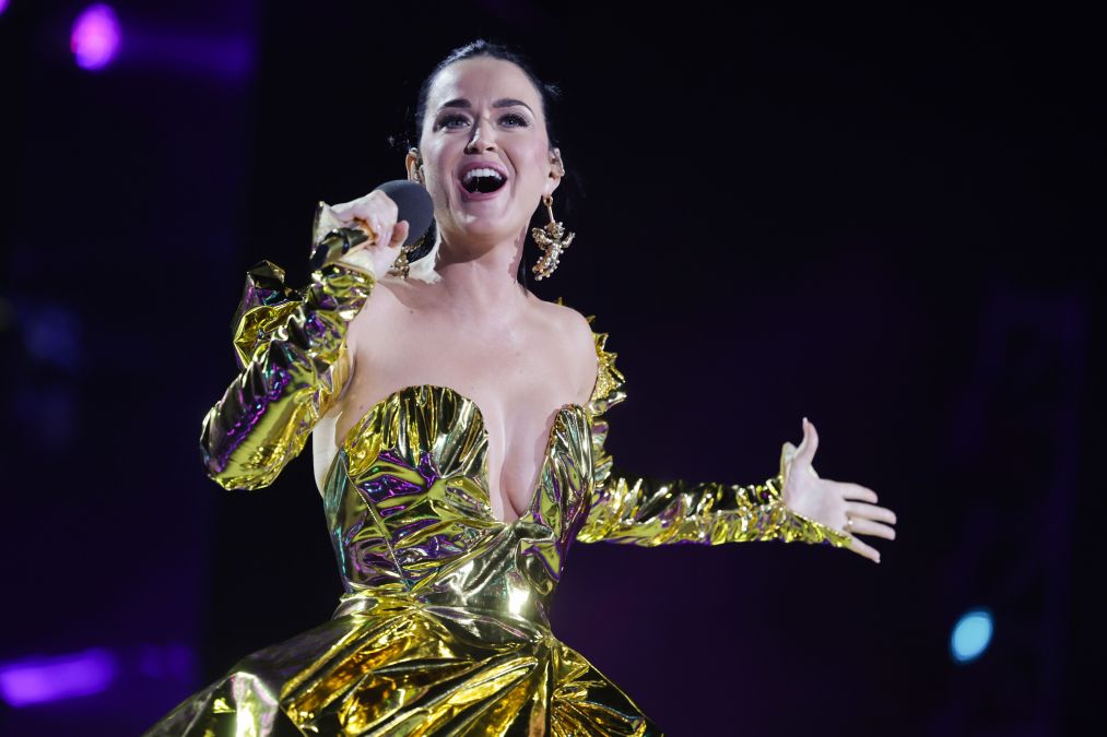 Katy Perry singing in a gold dress