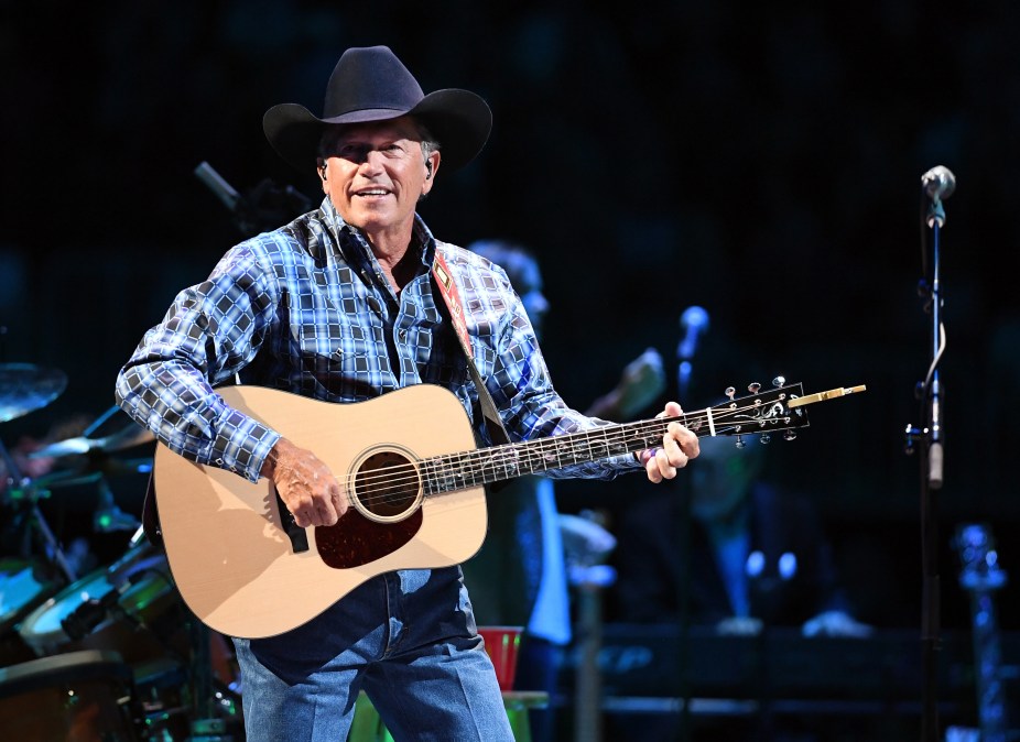 George Strait playing guitar.