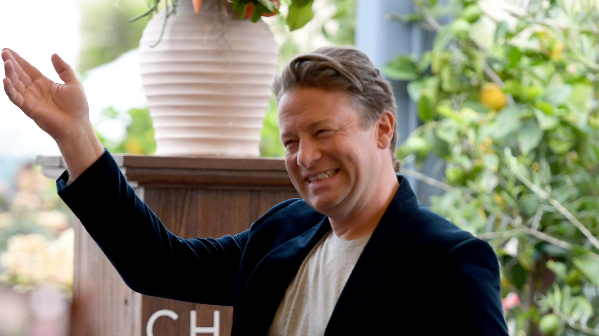 Jamie Oliver smiling and attending an event