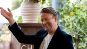Jamie Oliver smiling and attending an event