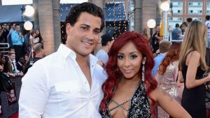 Television personality Nicole 'Snooki' Polizzi (Detail: NYC Glitz dress) (R) with husband Jionni LaValle (L) attend the 2013 MTV Video Music Awards at the Barclays Center on August 25, 2013