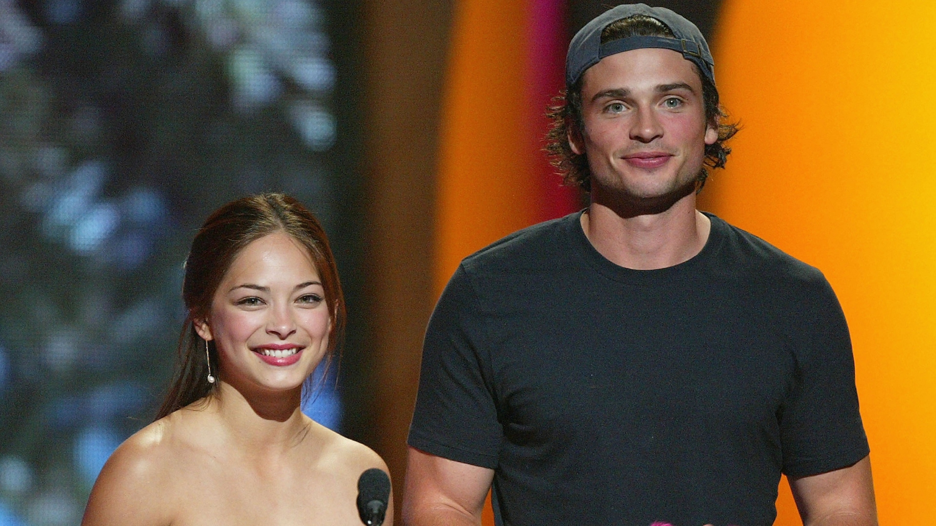 Kristin Kreuk and Tom Welling smiling at an event