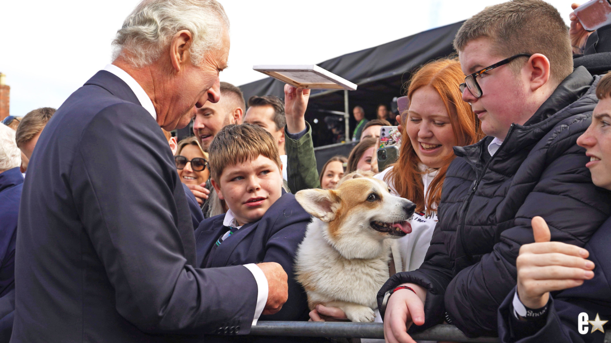 King Charles III meets a woman holding a corgi