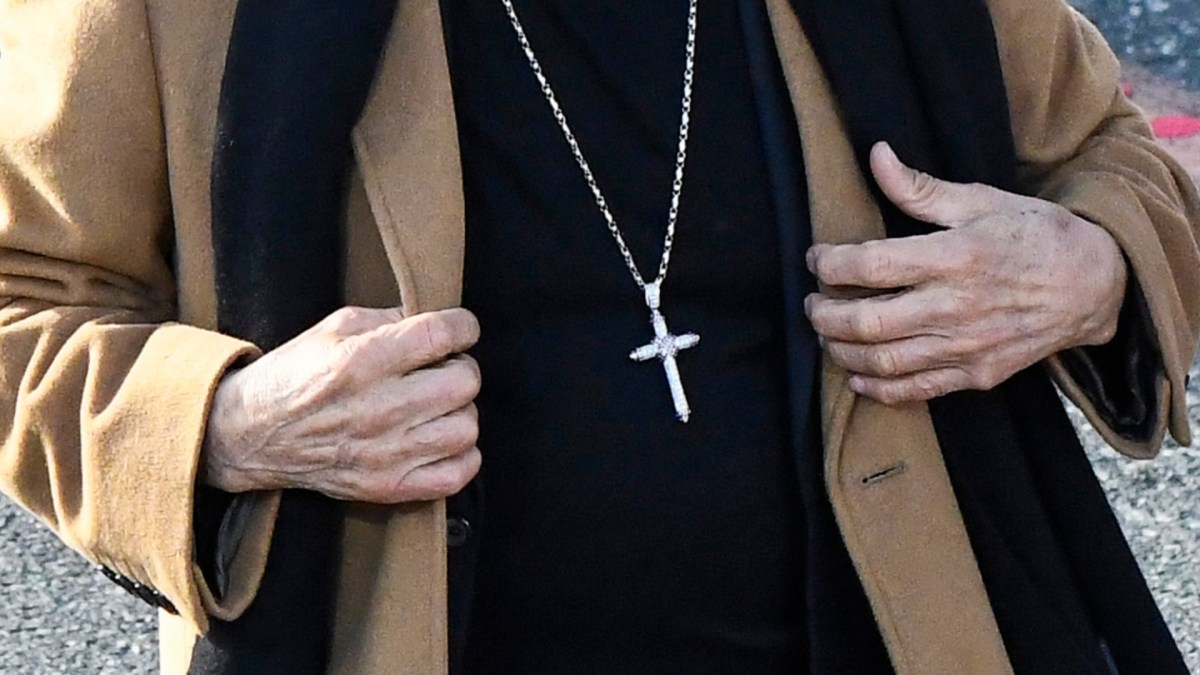 Danny Trejo's hands and cross necklace