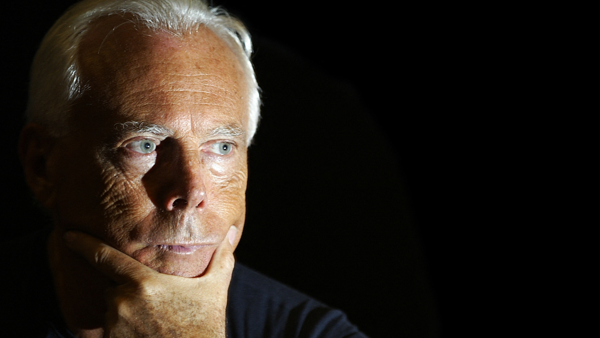 Giorgio Armani poses for photo
