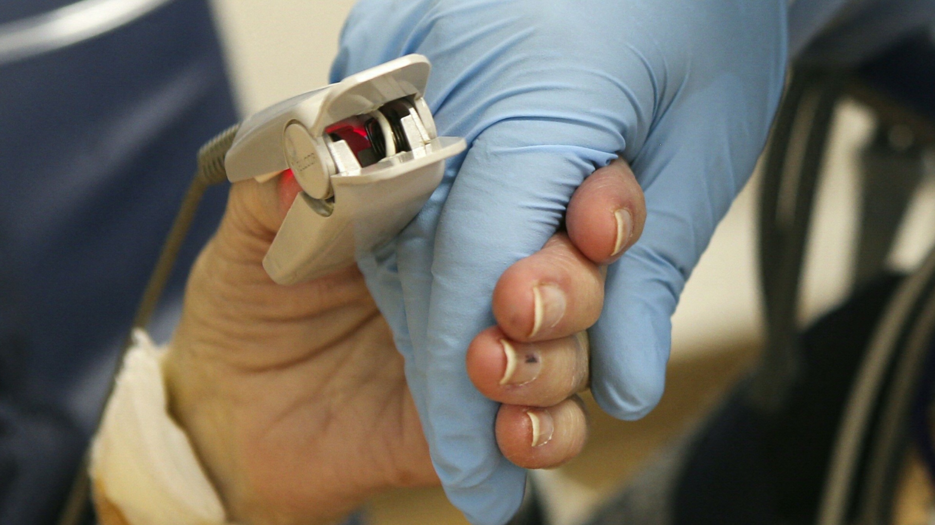 Woman holding hands of a medical professional
