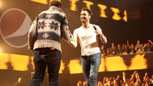 Singer Travie McCoy of Gym Class Heroes and singer Adam Levine perform onstage