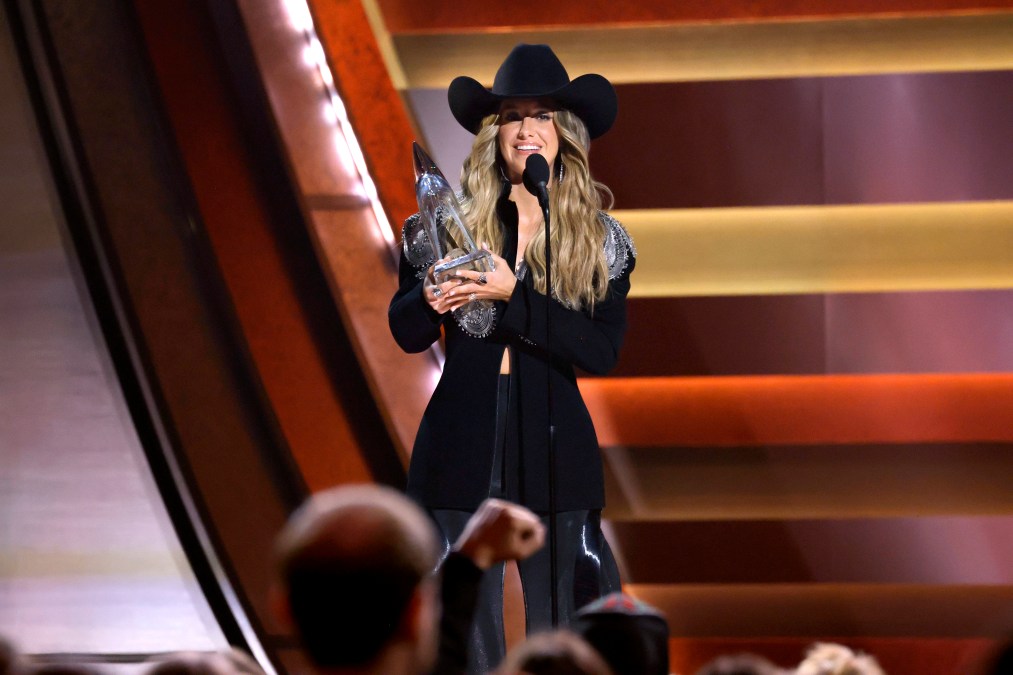 Lainey Wilson smiles with award at 2025 CMAs