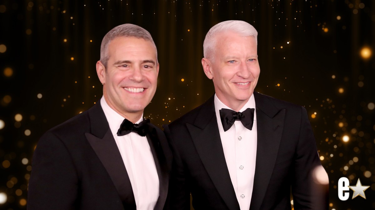 Andy Cohen and Anderson Cooper waring suits and smiling