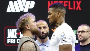 Jake Paul and Anthony Joshua face off during a press conference for Jake Paul v Anthony Joshua at Kaseya Center