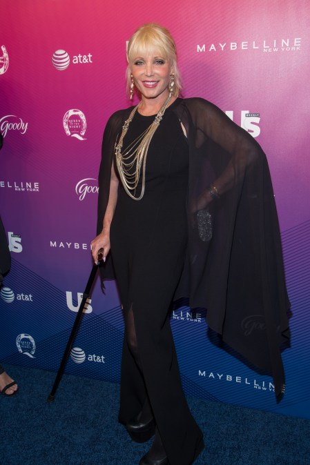 Pamela Bach&nbsp;smiling and walking with a cane