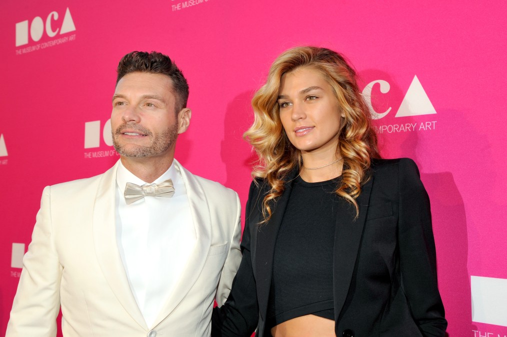 Ryan Seacrest and Shayna Taylor smiling at an event