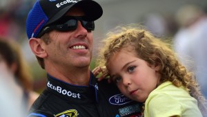 Greg Biffle smiles while holding daughter Emma