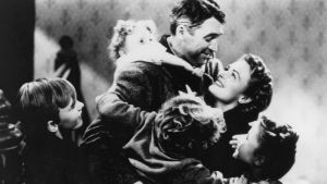 American actors James Stewart (1908 - 1997) and Donna Reed (1921 - 1986) star in the film 'It's a Wonderful Life', 1946. The children are Jimmy Hawkins (Tommy Bailey), Karolyn Grimes (Zuzu Bailey), Larry Simms (Peter Bailey) and Carol Coombs (Janie Bailey)