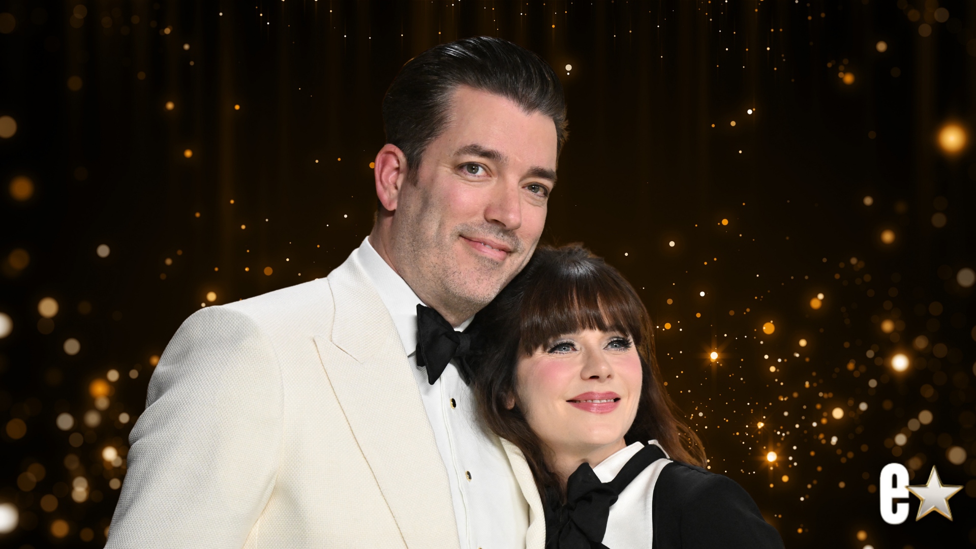 Jonathan Scott and Zooey Deschanel smiling at an event