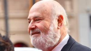 Rob Reiner smiling and walking