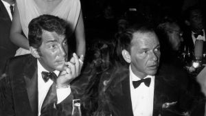 American singers and actors Dean Martin (1917 - 1995) (L) and Frank Sinatra attend the opening night performance of American singer Eddie Fisher at the Cocoanut Grove, Hollywood, California